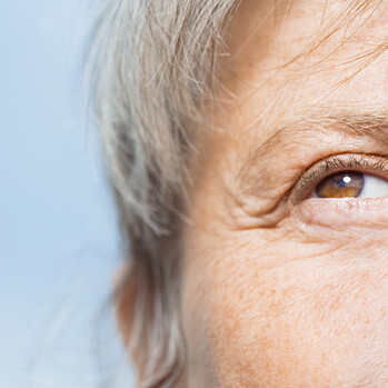 Gesichtsausschnitt mit Fokus auf das Auge einer älteren Person