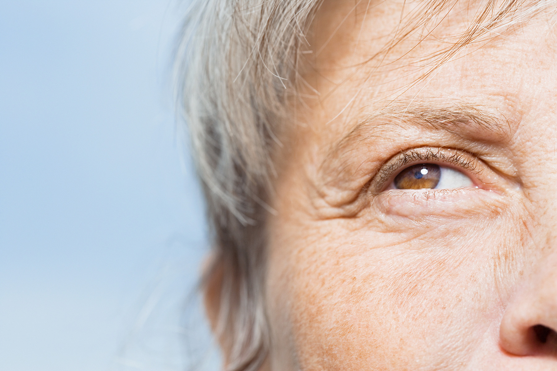 Gesichtsausschnitt mit Fokus auf das Auge einer älteren Person